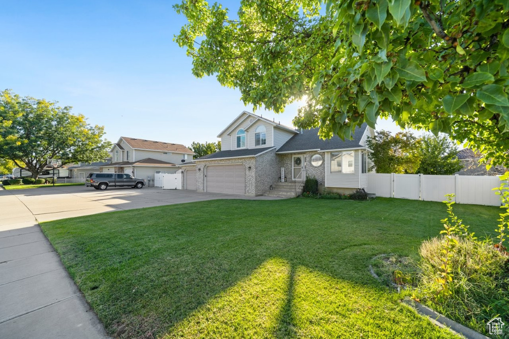 Traditional-style house with concrete driveway and brick siding