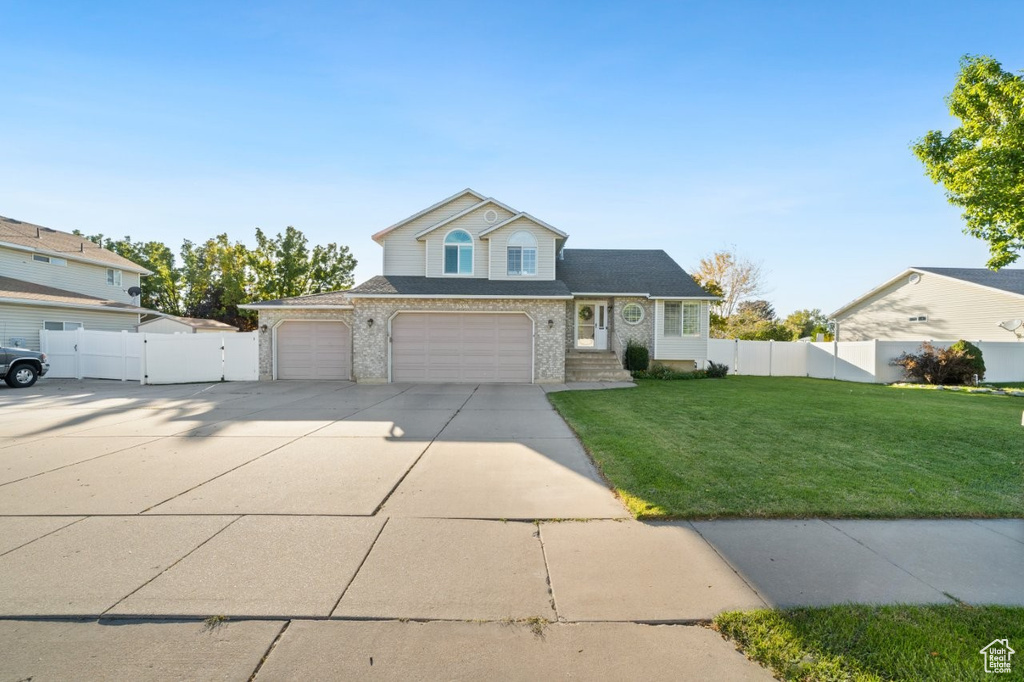 Traditional-style house with driveway and brick siding