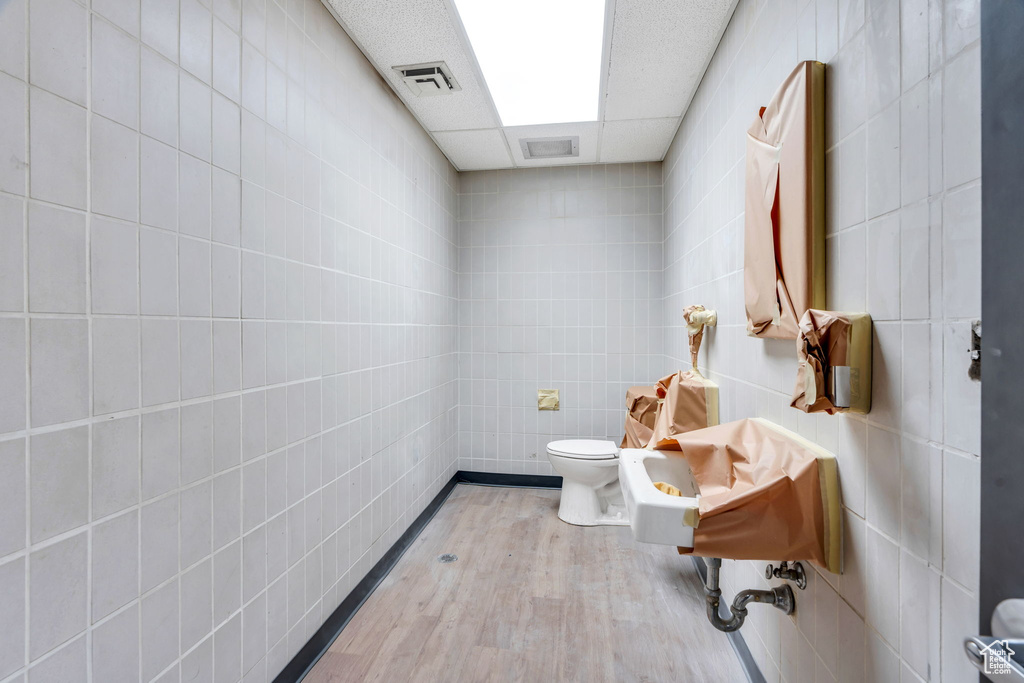 Bathroom with tile walls and toilet