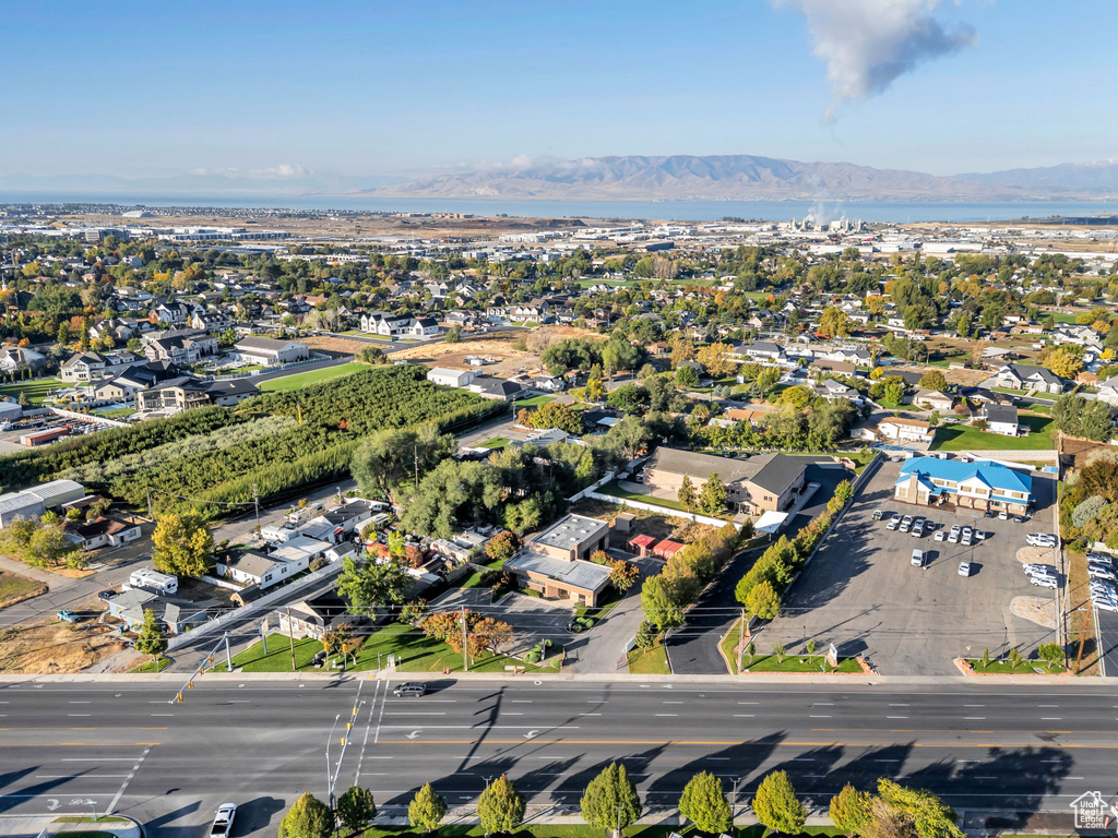 Aerial view of property and surrounding area with a water and mountain view
