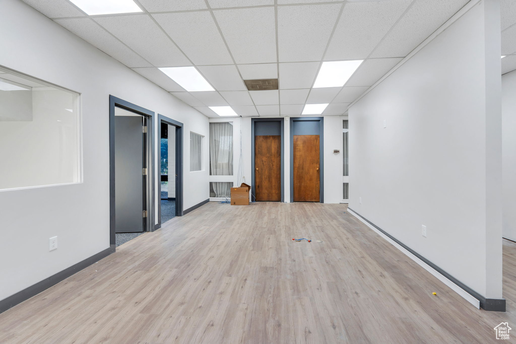Spare room featuring a drop ceiling and light wood-style flooring