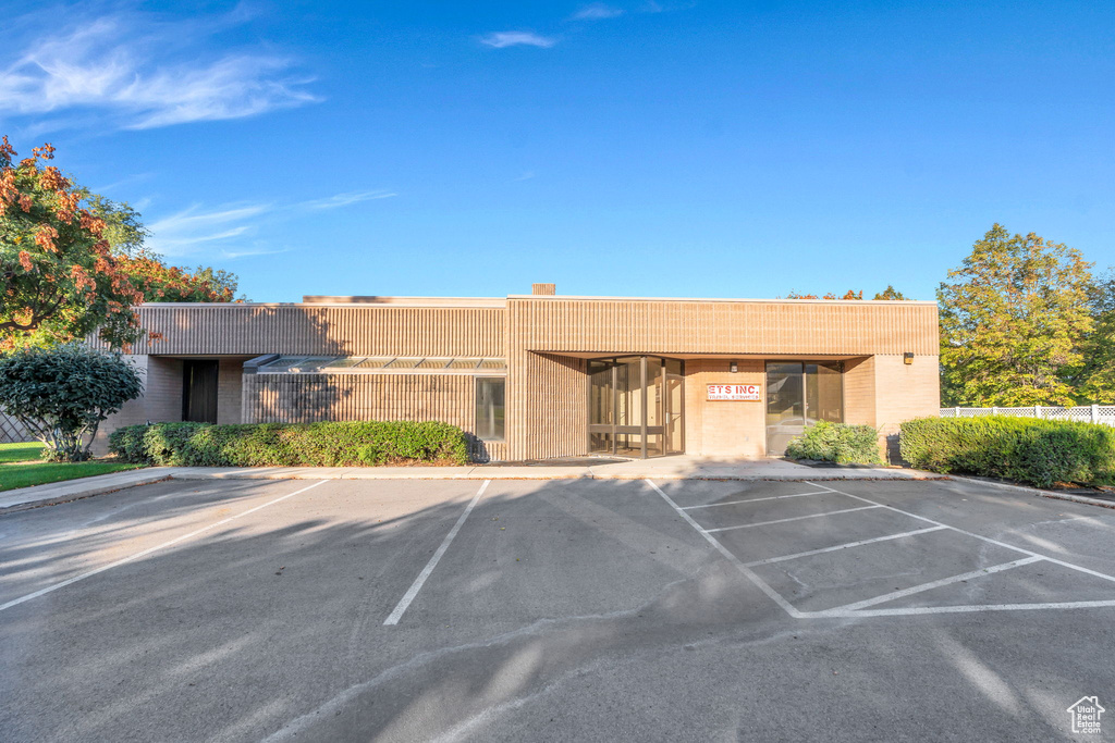 View of property featuring uncovered parking
