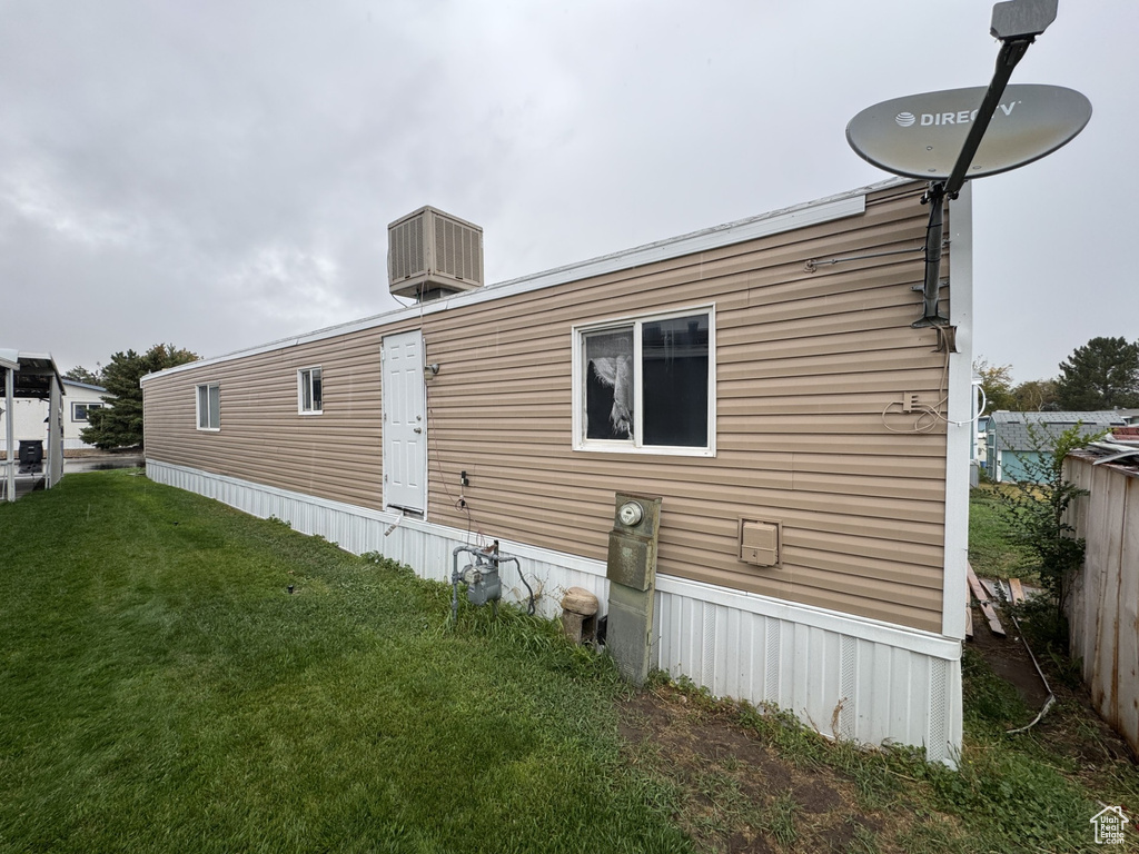 Rear view of property with a lawn