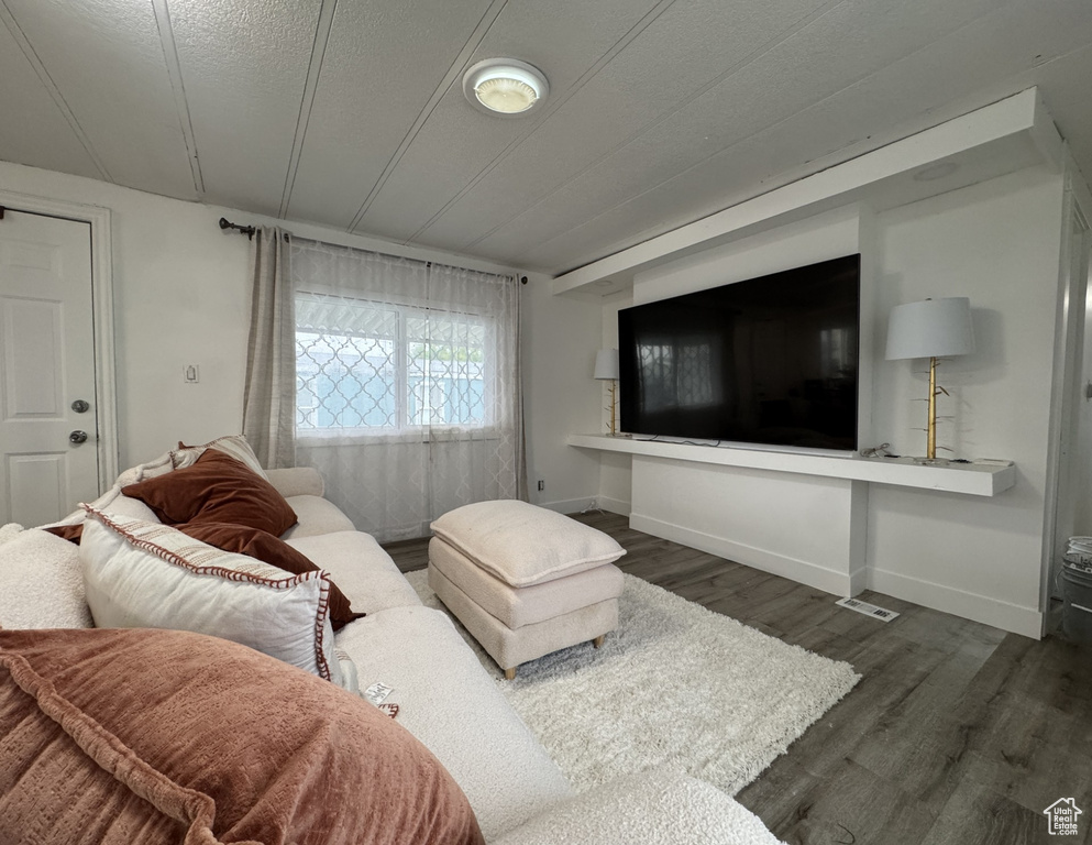 Living area featuring dark wood finished floors and baseboards