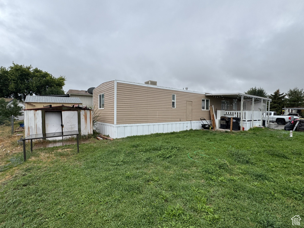 Rear view of property with a yard