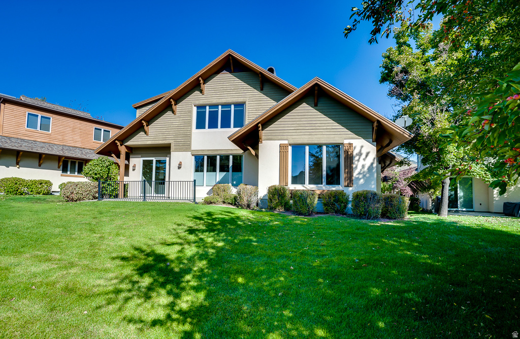 Back of house with a lawn