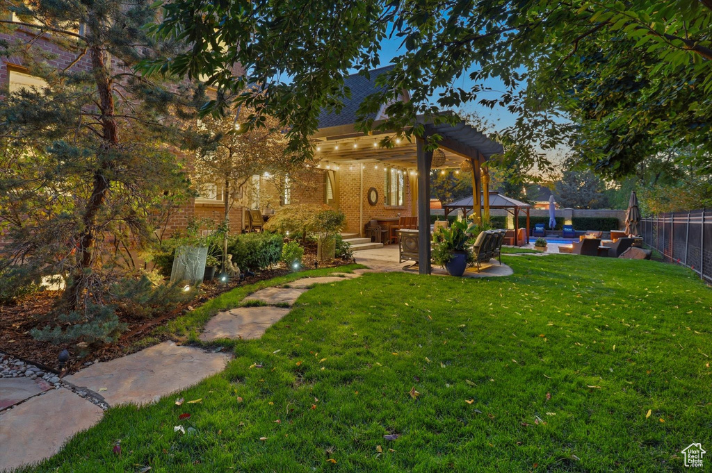 Fenced backyard with an outdoor hangout area, a patio area, and a pergola