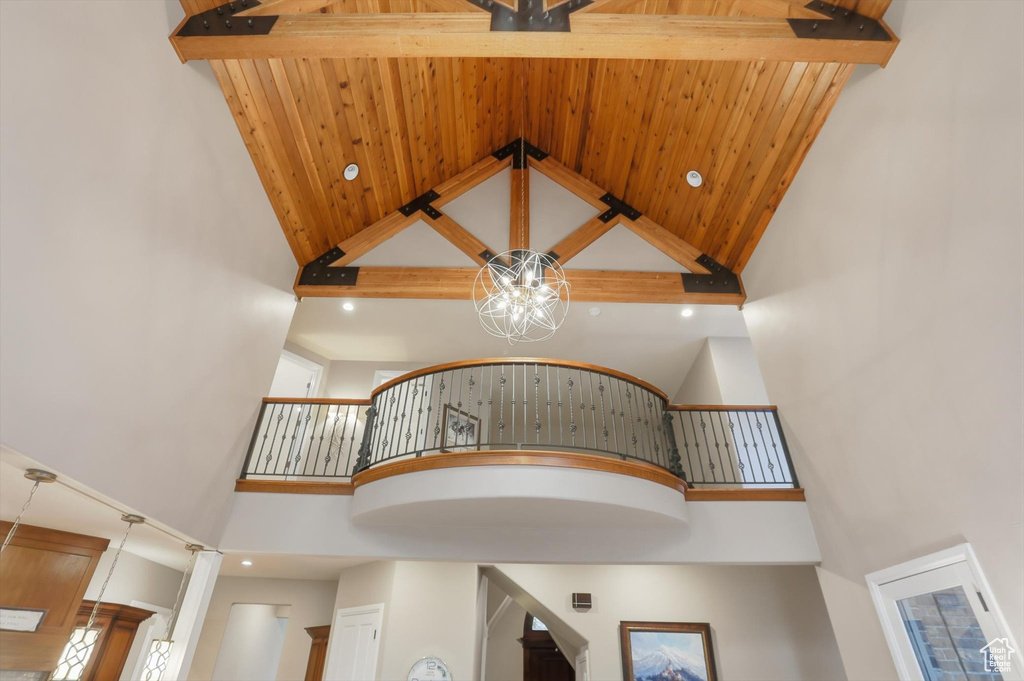 Stairs featuring recessed lighting, high vaulted ceiling, beamed ceiling, and a chandelier