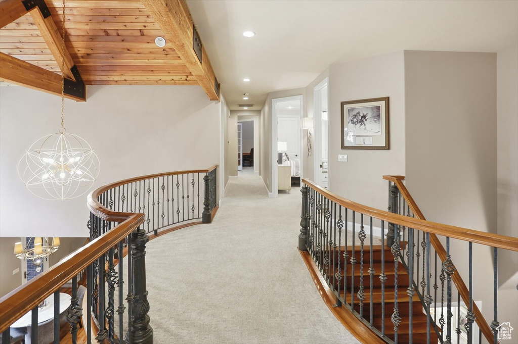 Corridor featuring recessed lighting, an upstairs landing, a chandelier, and light carpet