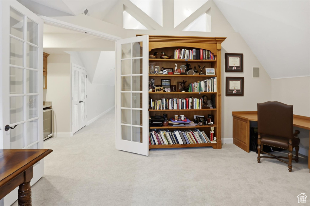 Office featuring french doors, light colored carpet, and lofted ceiling