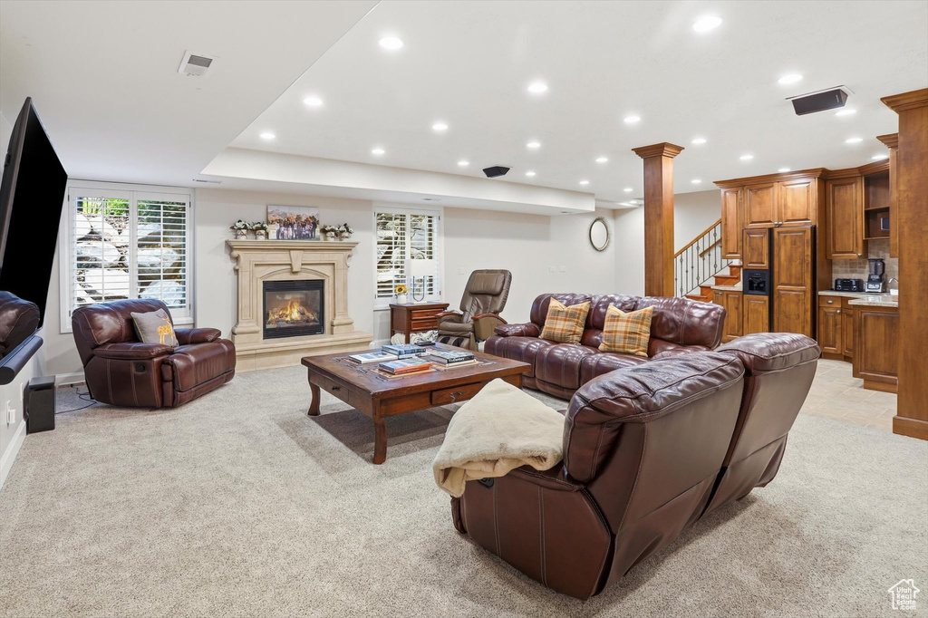 Living area featuring recessed lighting, light carpet, stairway, and a fireplace