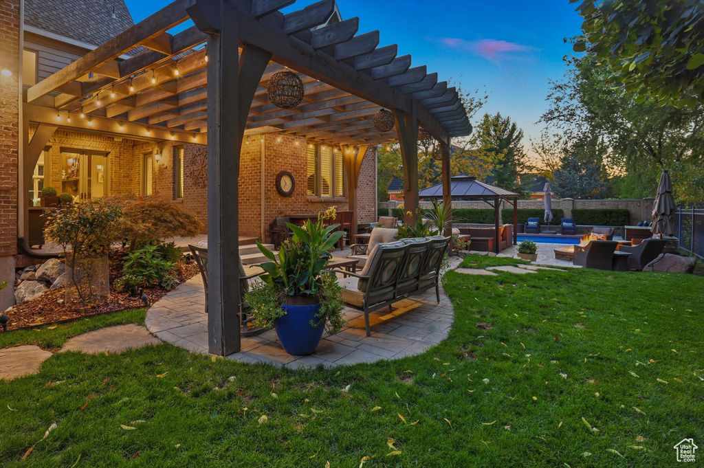 Fenced backyard with outdoor lounge area, a patio area, a gazebo, and a pergola