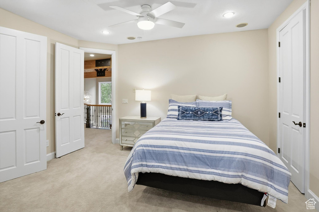 Bedroom with light carpet, recessed lighting, and a ceiling fan