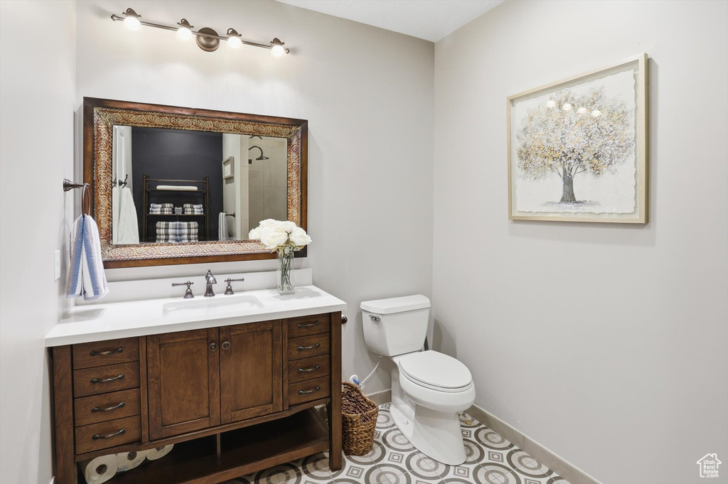 Full bath featuring vanity, tile patterned flooring, and a shower
