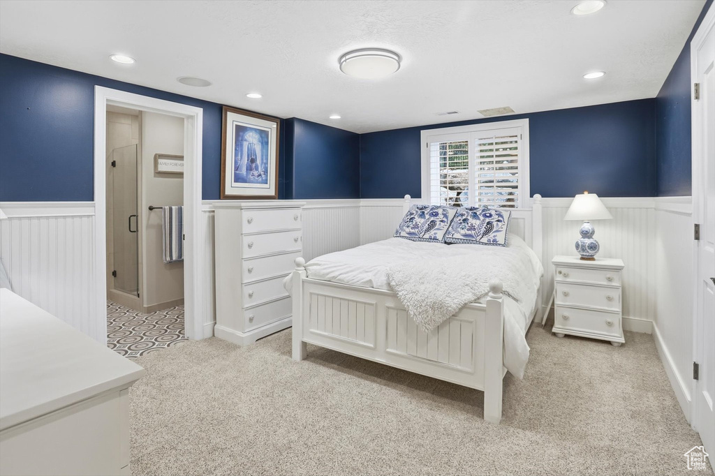 Bedroom featuring a wainscoted wall, light carpet, and recessed lighting