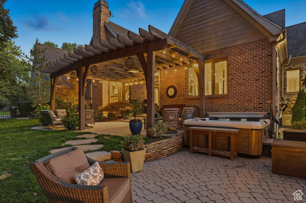 View of patio with a pergola and a hot tub