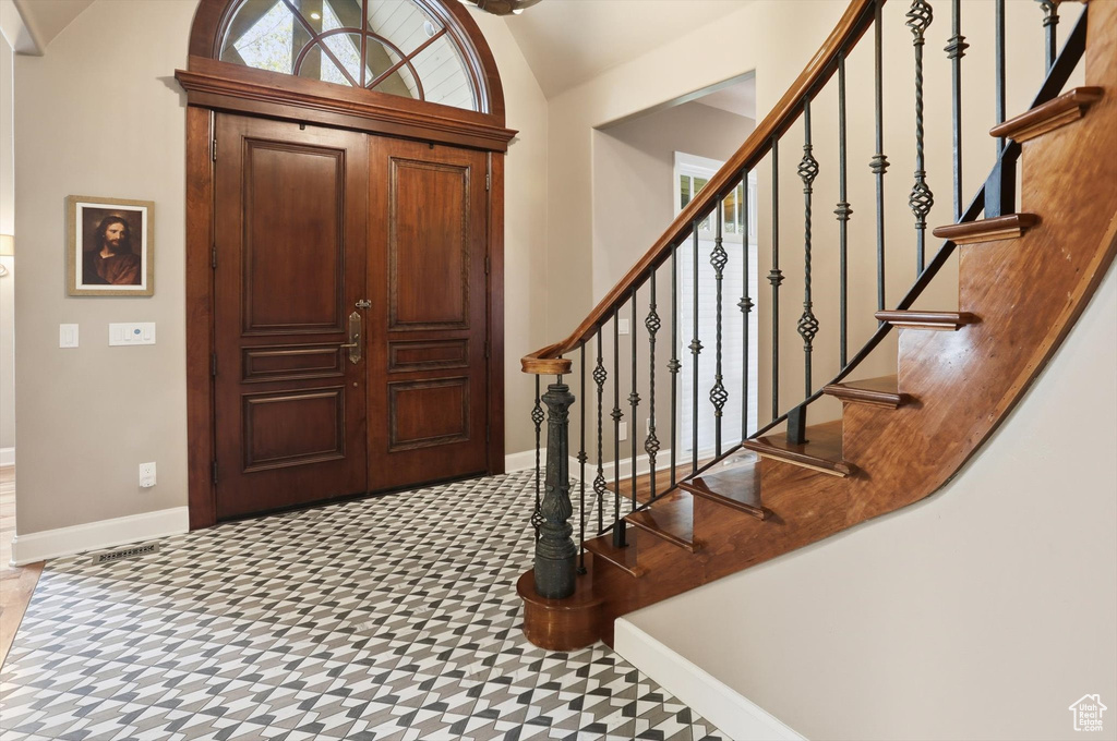 Foyer featuring lofted ceiling and healthy amount of natural light