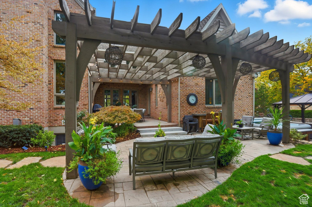 View of patio featuring an outdoor hangout area, a pergola, and grilling area
