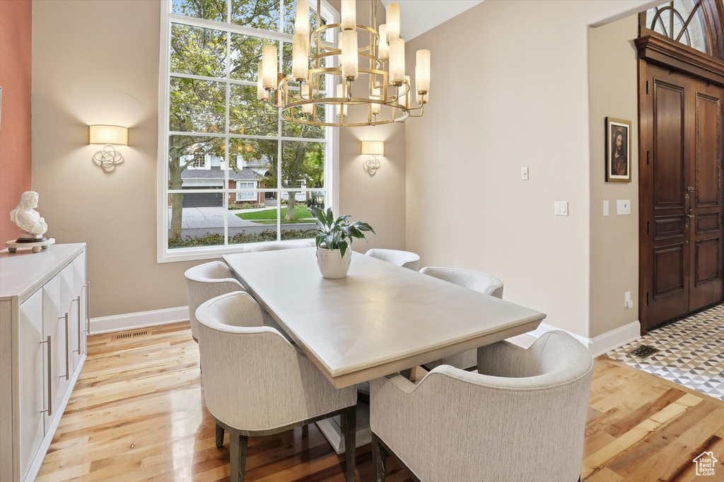 Dining space with light wood-style flooring and a chandelier