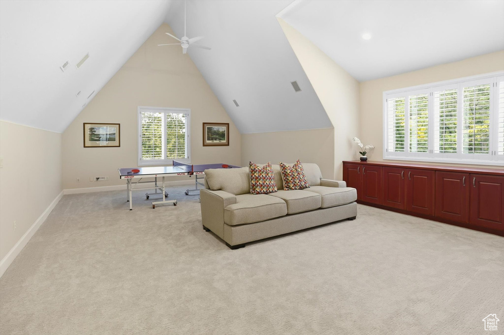 Office space with light carpet, lofted ceiling, and a ceiling fan