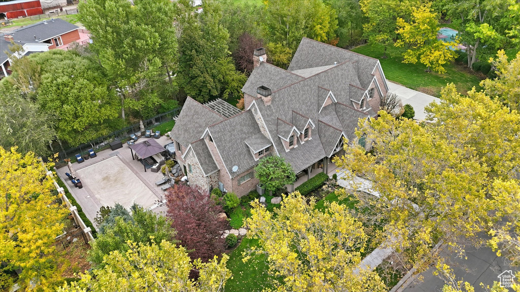 View of subject property with a tree filled landscape