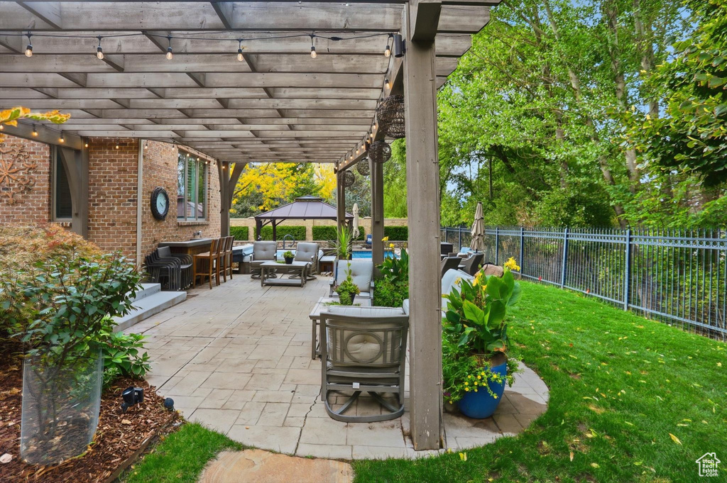 Fenced backyard featuring a gazebo, outdoor lounge area, a patio area, and outdoor dining area