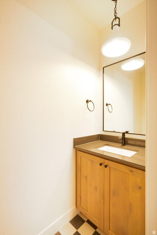 Bathroom with vanity and light flooring