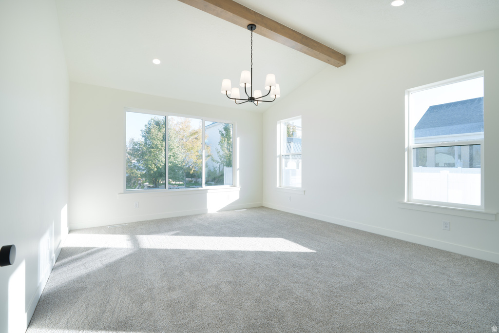 Empty room with recessed lighting, healthy amount of natural light, carpet, and a chandelier