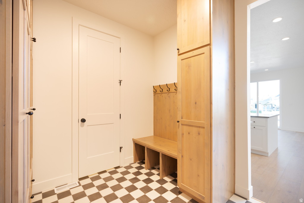 Mudroom featuring light flooring and recessed lighting