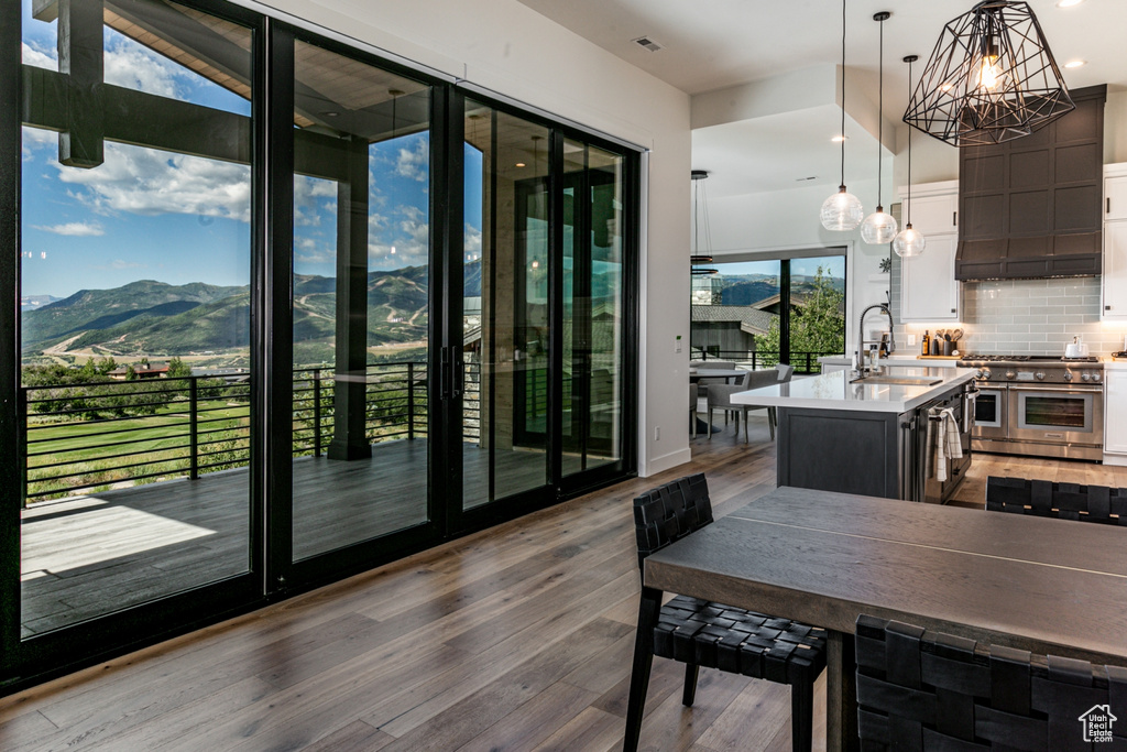 Dining space featuring dark wood-style floors, a mountain view, a chandelier, and recessed lighting