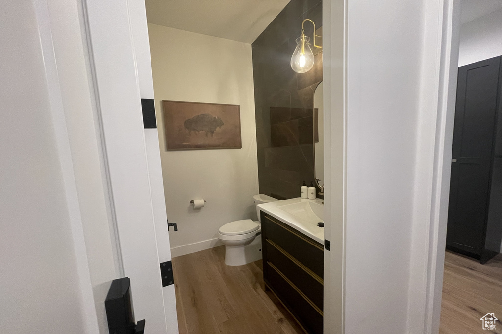 Half bath featuring vanity and wood finished floors