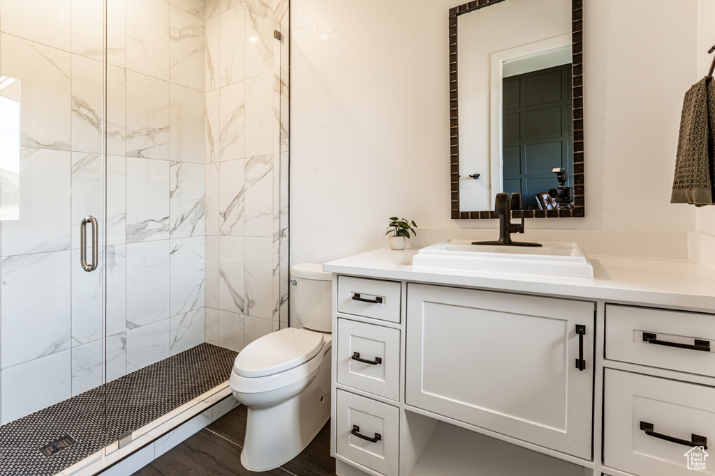 Full bathroom with vanity and a marble finish shower