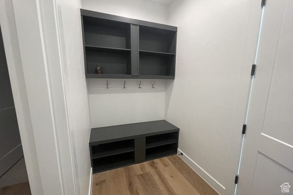 Mudroom featuring light wood finished floors and baseboards