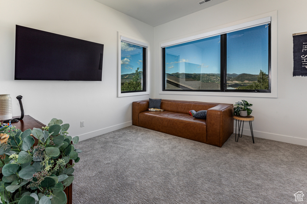 Living area with carpet and baseboards