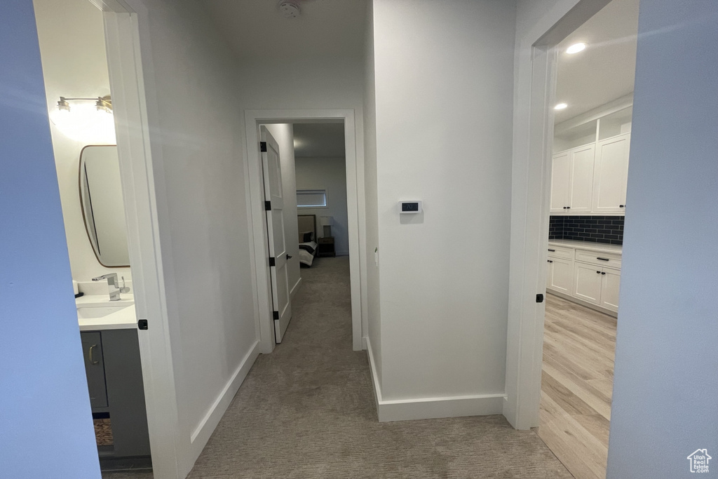 Hall with light carpet and recessed lighting