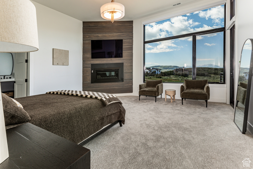 Carpeted bedroom with a large fireplace