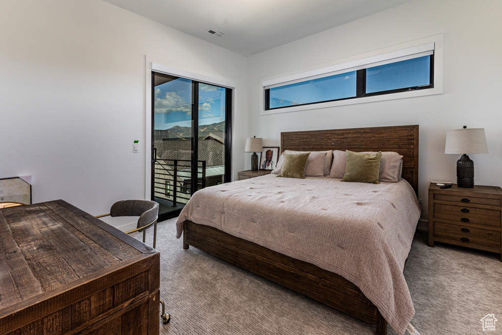 Carpeted bedroom with access to outside