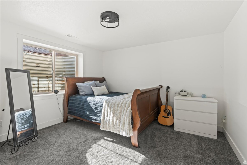 Bedroom with carpet flooring and baseboards