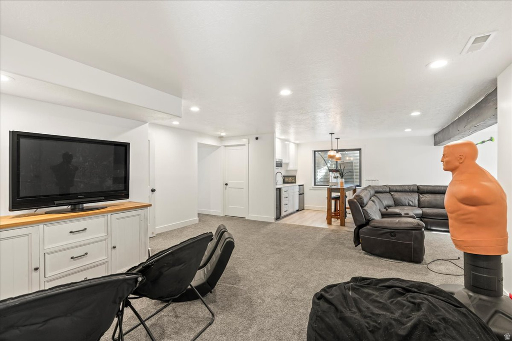 Living room with light carpet and recessed lighting