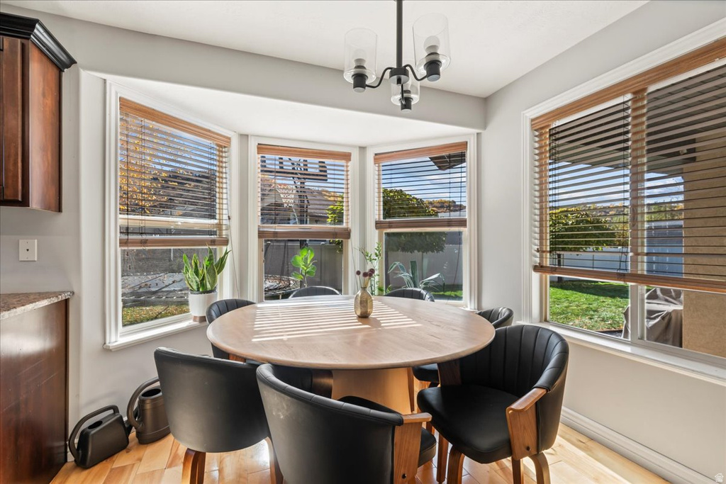 Dining room featuring a chandelier and light wood-type flooring