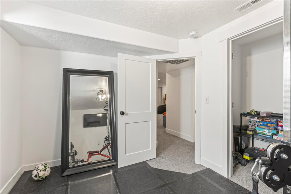 Workout area featuring a textured ceiling