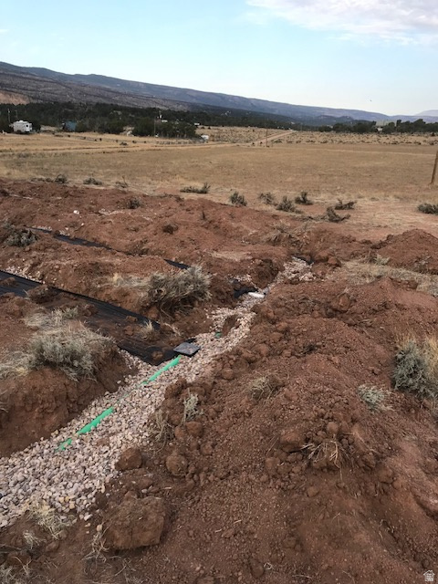 Aerial view of property and surrounding area with rural landscape and a mountain backdrop