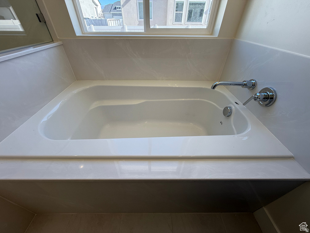 Bathroom featuring a garden tub and plenty of natural light