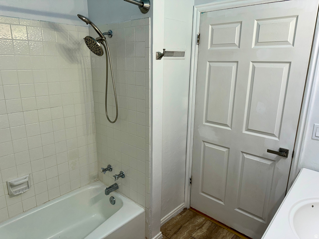 Bathroom with  shower combination, vanity, and dark wood finished floors