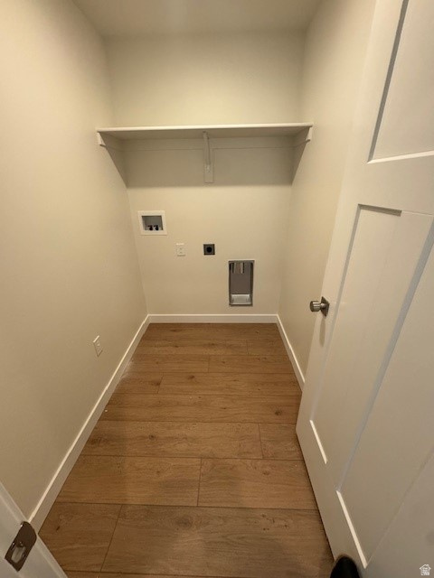 Laundry room featuring light wood-type flooring, hookup for an electric dryer, and hookup for a washing machine