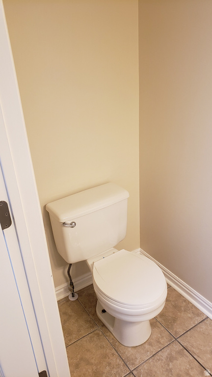 Bathroom featuring baseboards and light tile patterned flooring