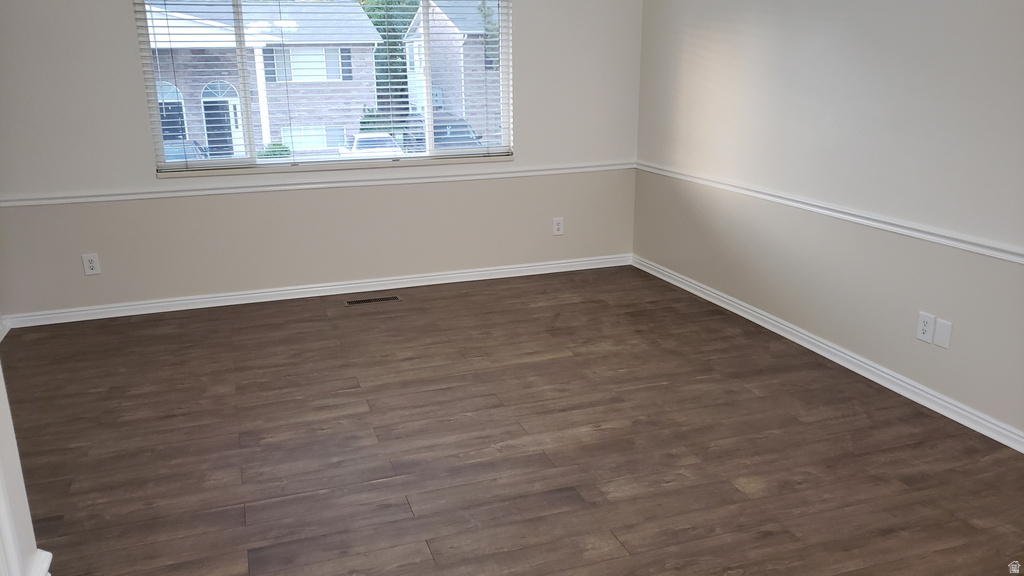 Unfurnished room with dark wood finished floors