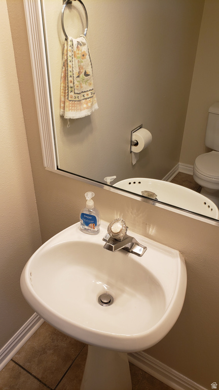 Bathroom with baseboards and tile patterned flooring