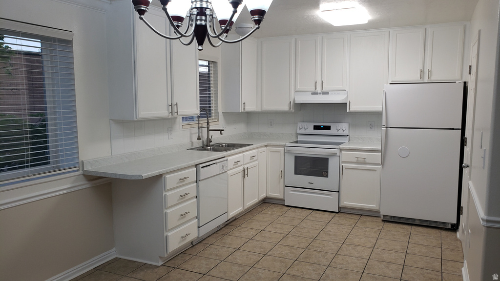 Kitchen with white appliances, white cabinetry, light countertops, tasteful backsplash, and light tile patterned floors