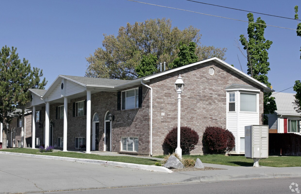 View of front of house featuring brick siding and a porch